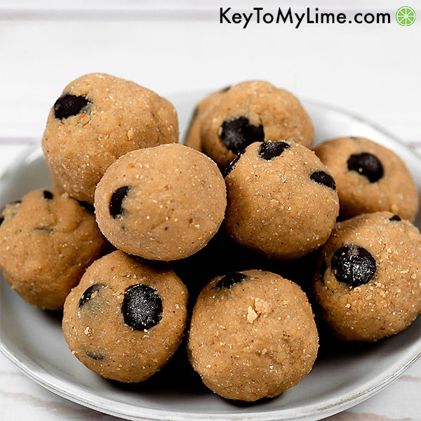 A pile of cookie dough energy balls on a plate.