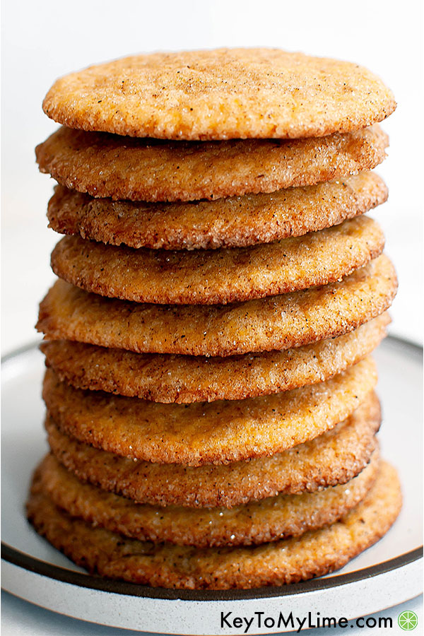 Pumpkin spice snickerdoodle cookies stacked on a plate.