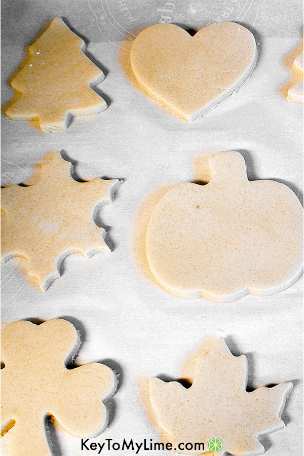 Cut out sugar cookies on a baking sheet ready to go in the oven.