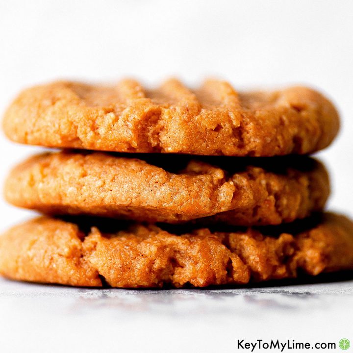 A stack of three vegan peanut butter cookies.
