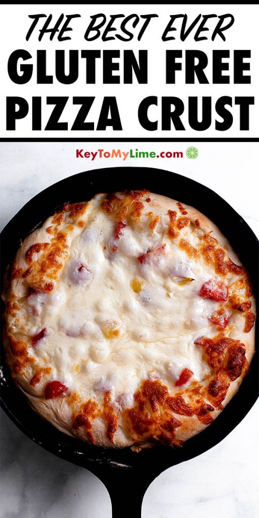 Gluten free pizza crust with cheese in a cast iron skillet.
