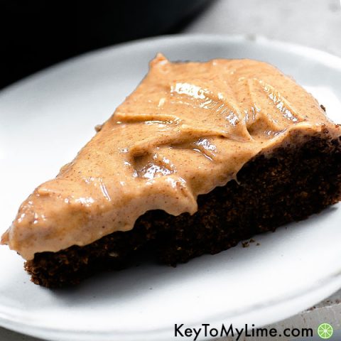 A slice of chocolate cake with vegan almond butter frosting.