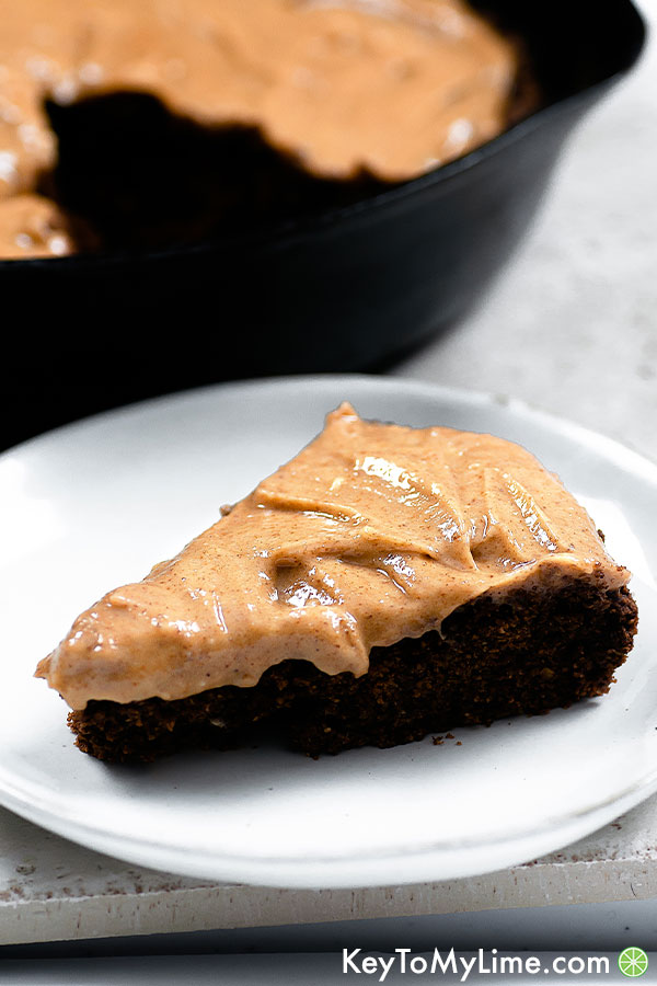 Almond butter frosting on a slice of chocolate cake.