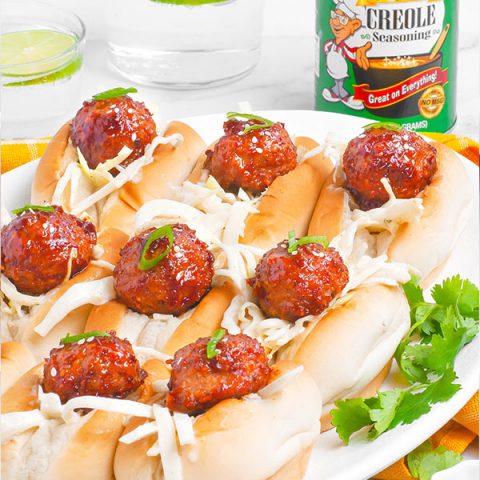 A side image of bbq meatball sliders on an oval platter.
