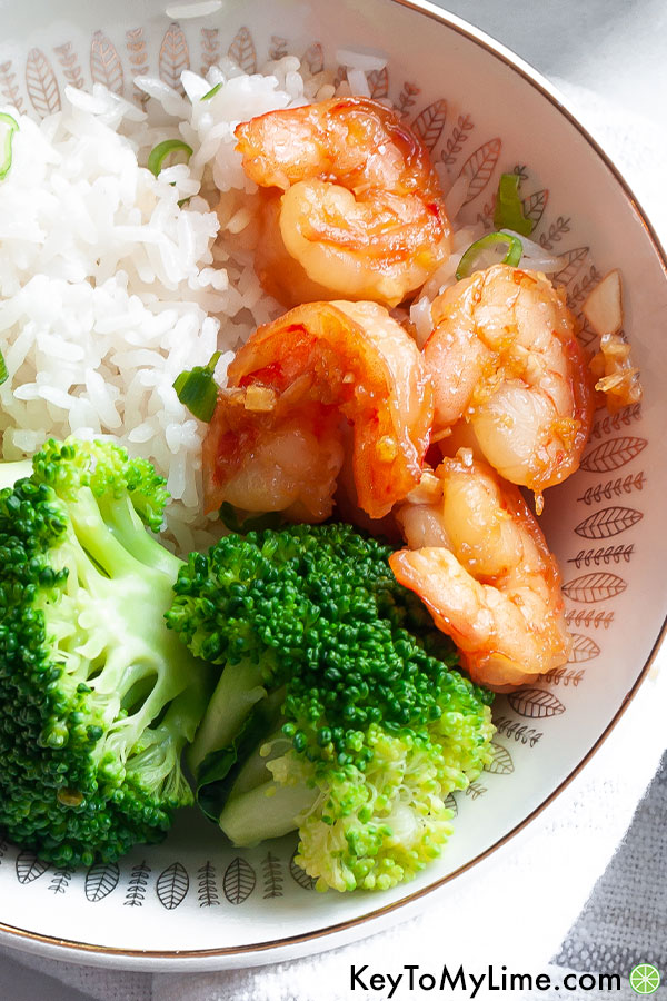 A close up image of honey garlic shrimp and broccoli.