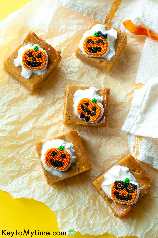 An overhead image of pumpkin pie bars on a yellow background.