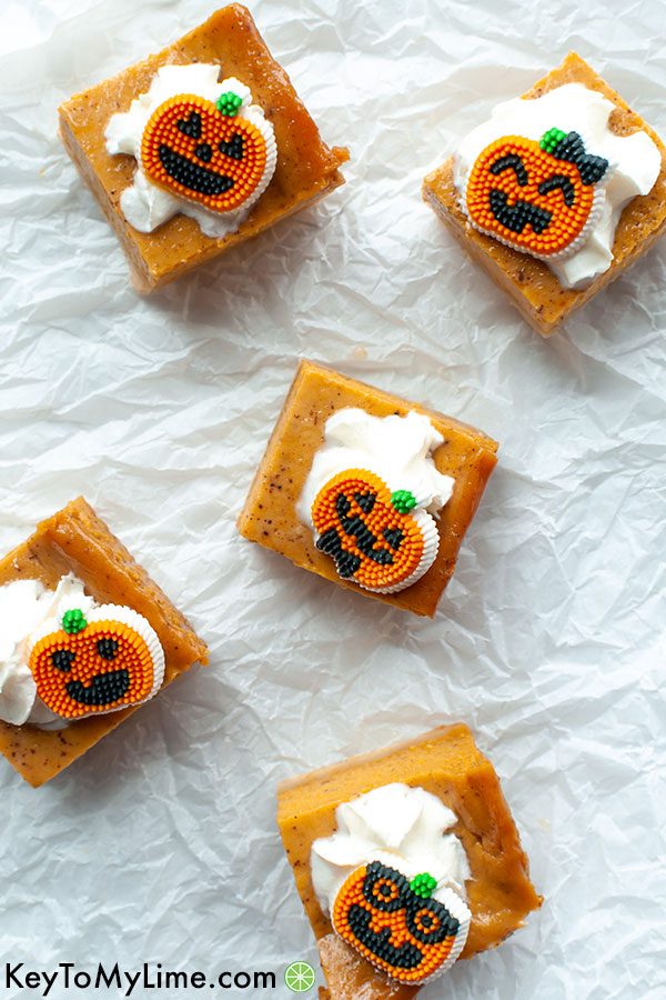 Pumpkin bars scattered on a piece of crumpled parchment paper.