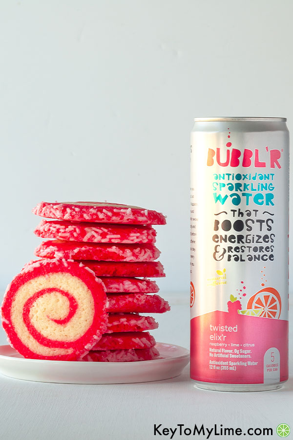 A stack of cookies next to a can of sparkling water.