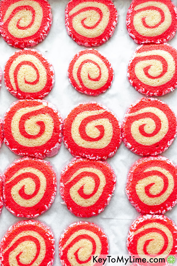 Christmas swirl cookies on a baking sheet fresh out of the oven.