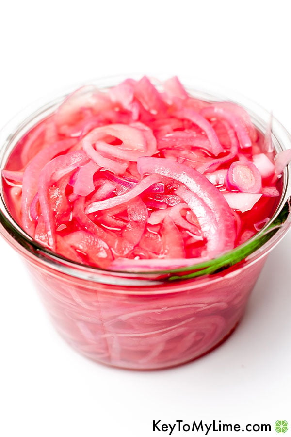 Quick pickled onions in a small jar.