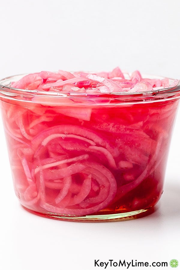 A side image of a jar of quick pickled onions.
