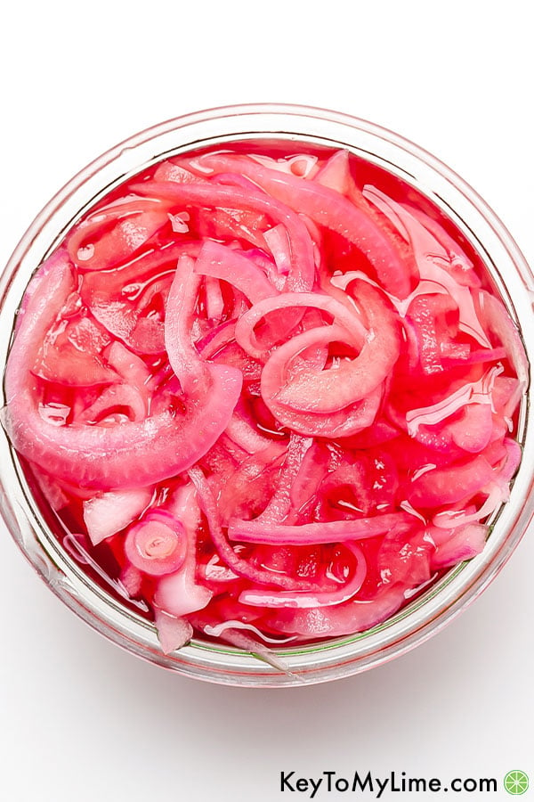 An overhead image of pickled red onions.