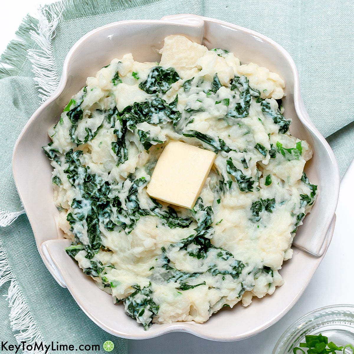 Colcannon potatoes with kale in a white bowl.