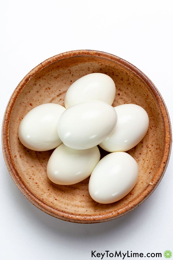Hard boiled eggs in a bowl showing how perfectly Instant Pot eggs peel.