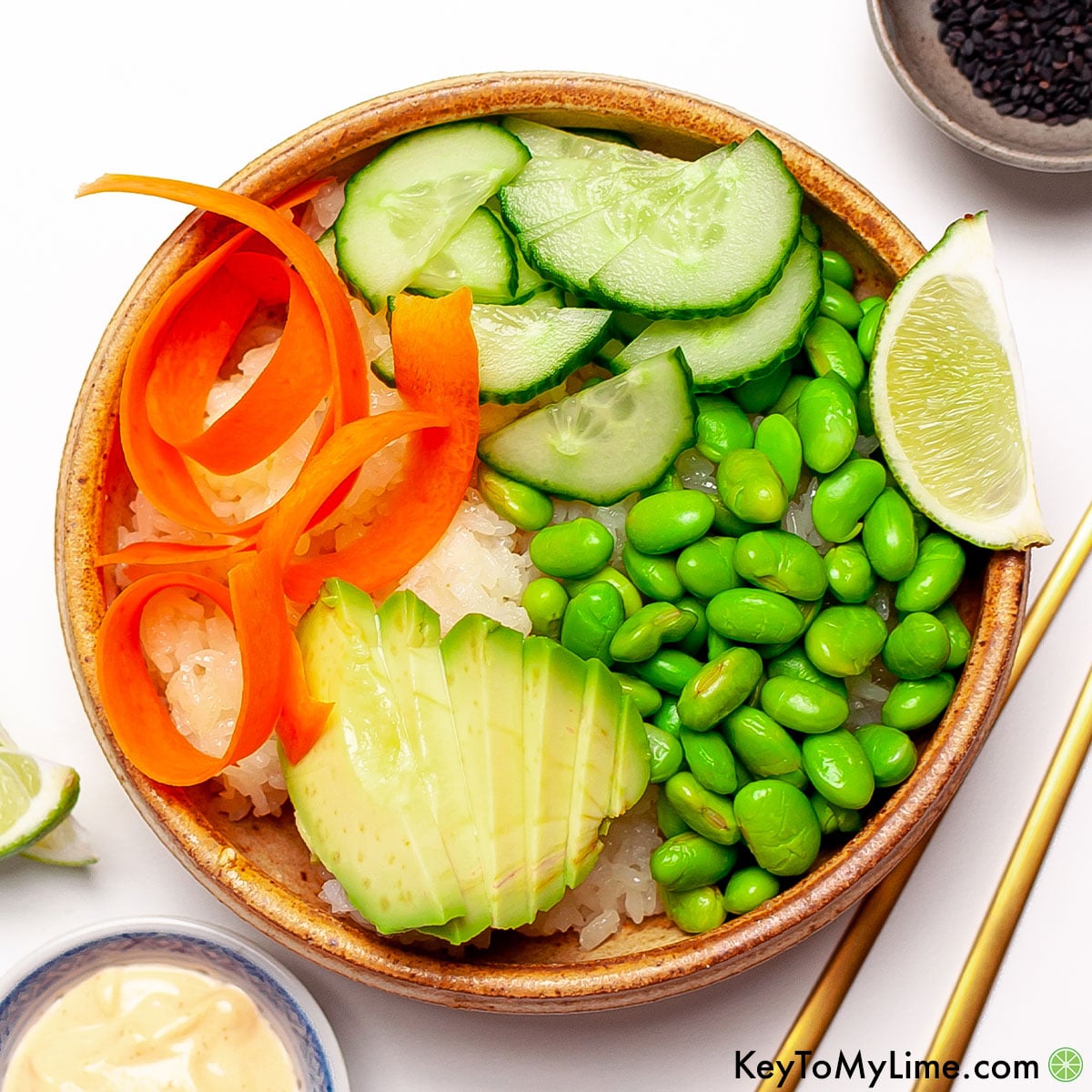An overhead image of vegetarian sushi bowl with sriracha mayo recipe.