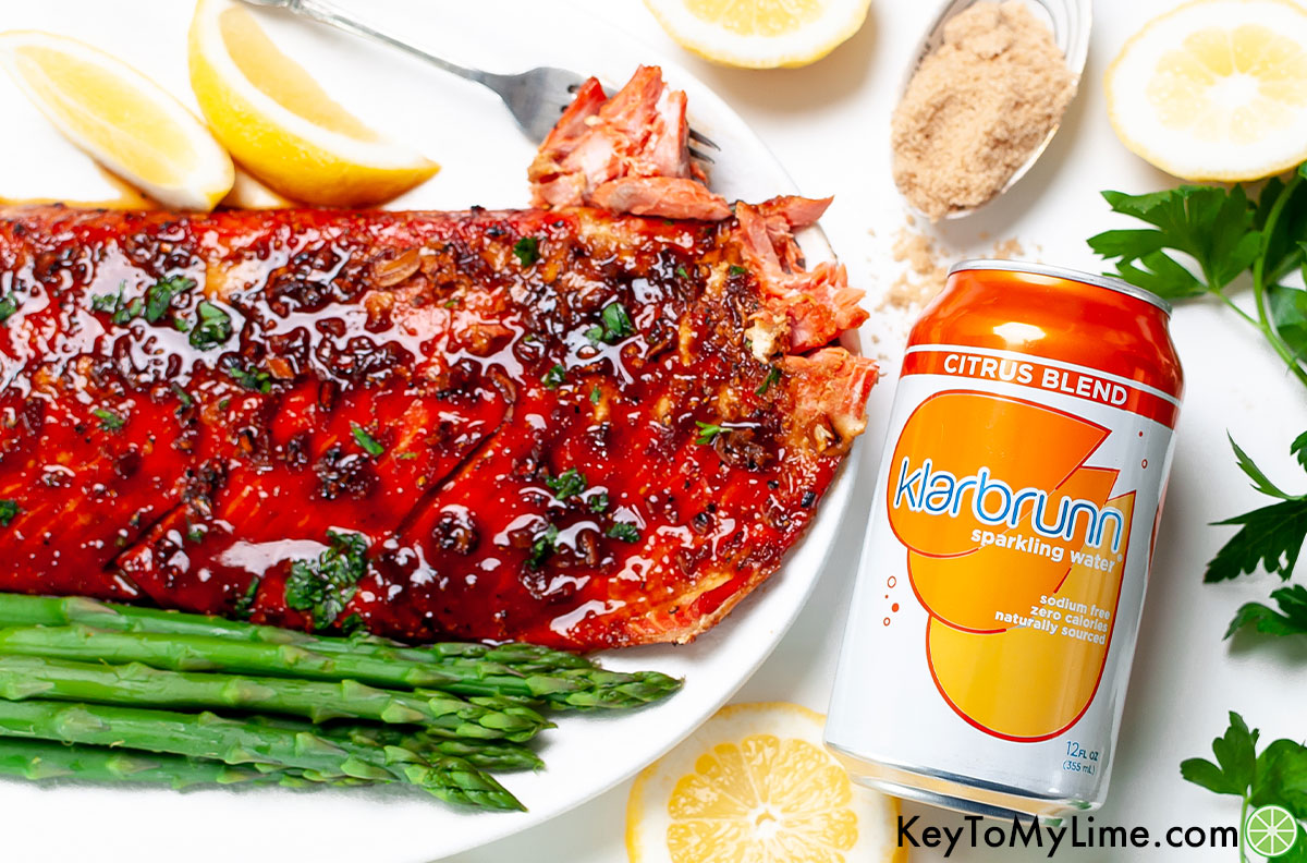 Glazed salmon next to a can of Klarbrunn sparkling water.