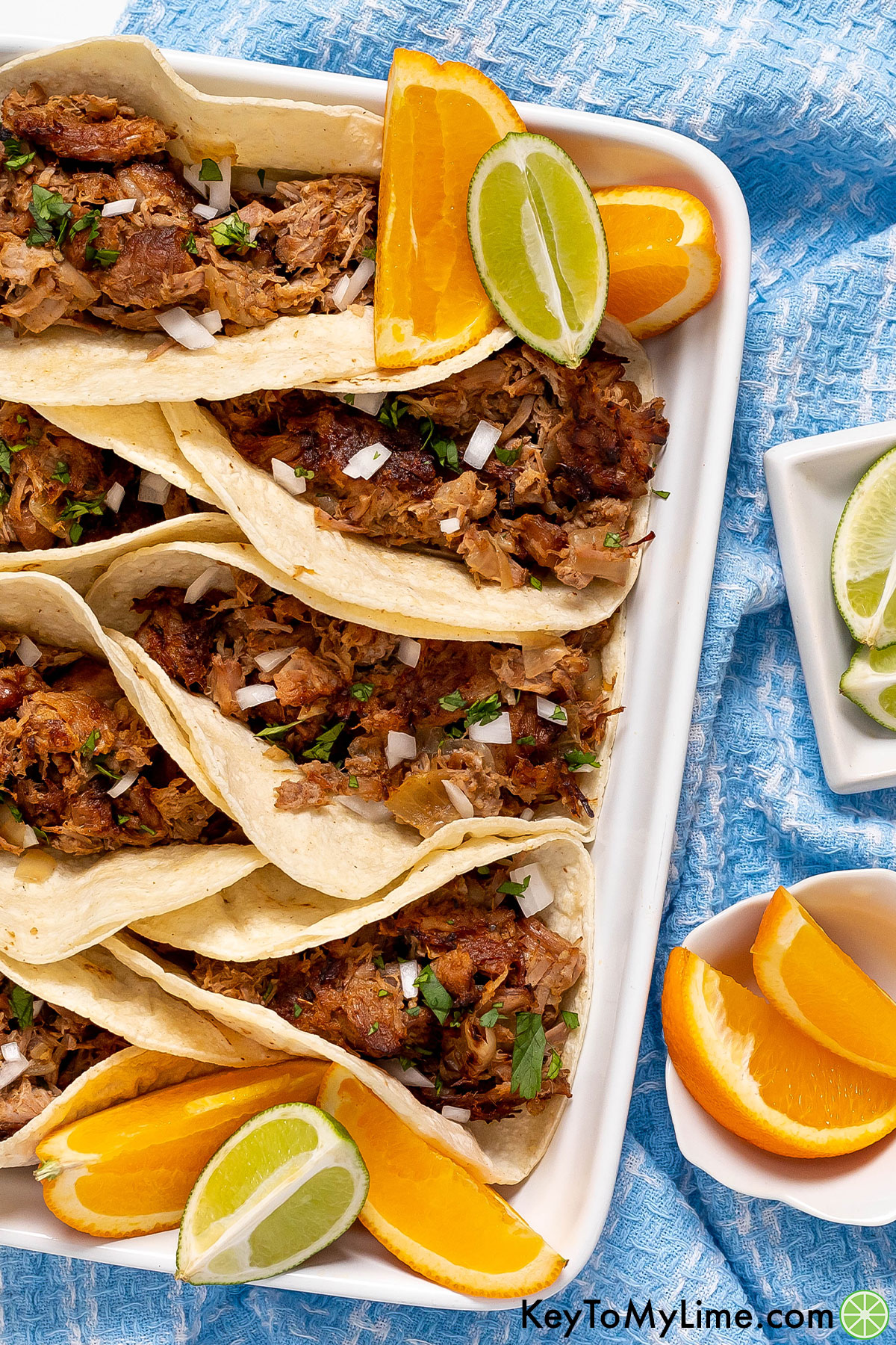 Pork carnitas that's been cooked in orange juice and lime juice.