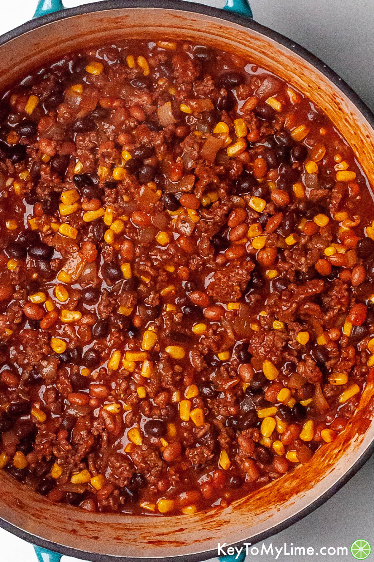 A close up overhead image of a pot full of sweet chili.
