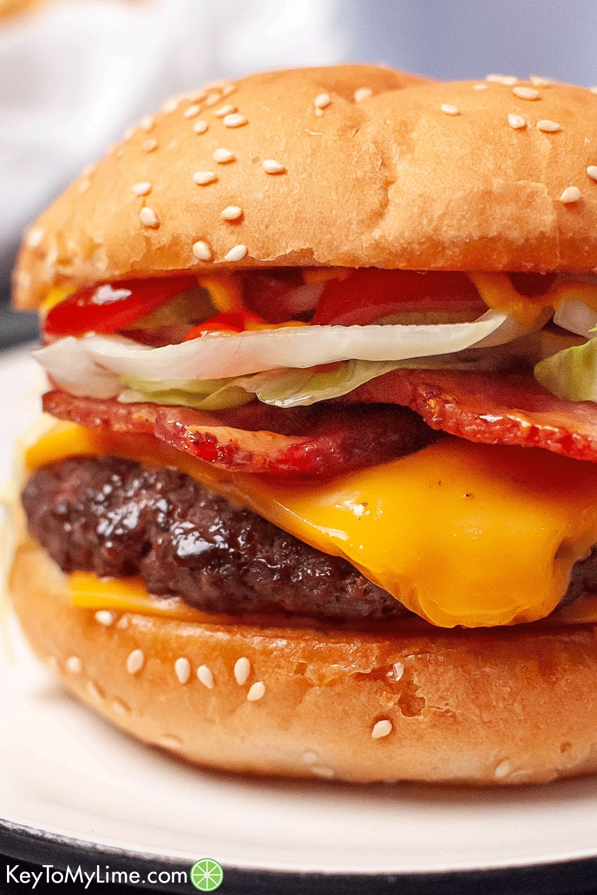 A close up image of a Travis Scott burger served on a sesame seed bun.