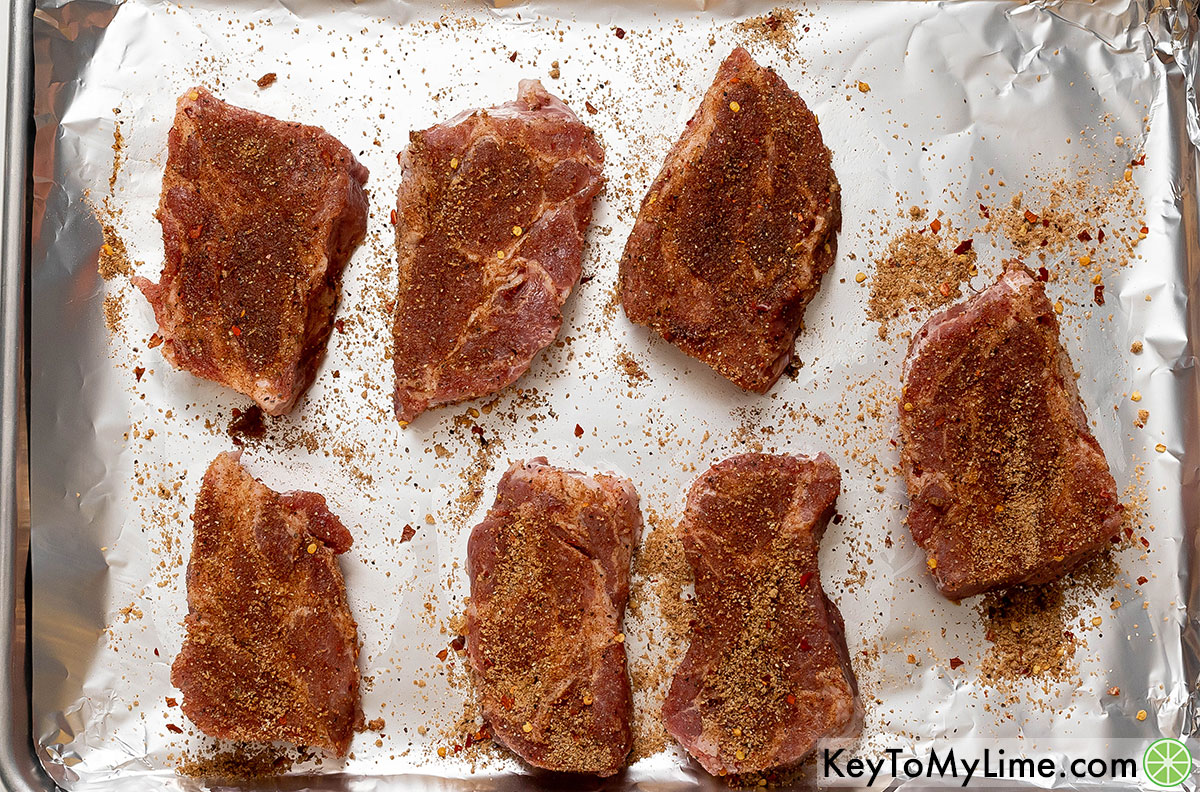 Evenly coat the country style ribs with homemade dry rub and place on a baking sheet.