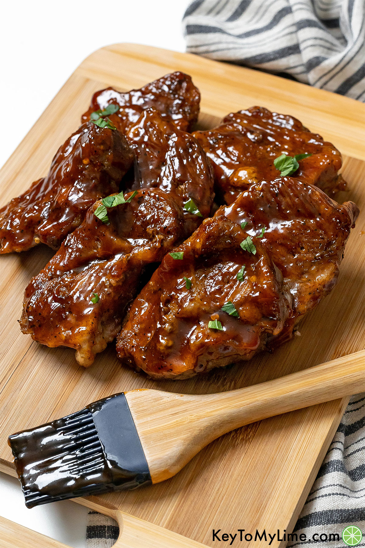 A side image of country style ribs with light glistening off of the BBQ sauce.