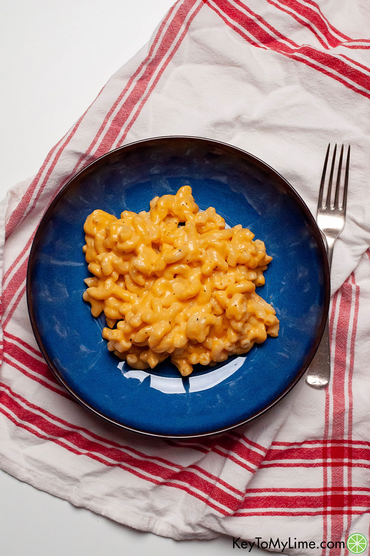 An overhead shot of mac and cheese plated with a fork to the side.