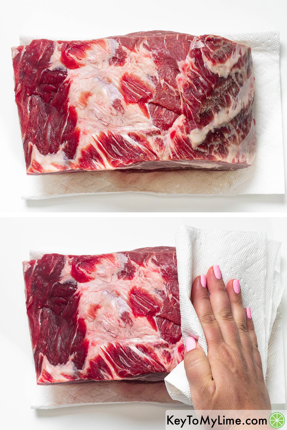 Patting a prime rib dry with paper towels.