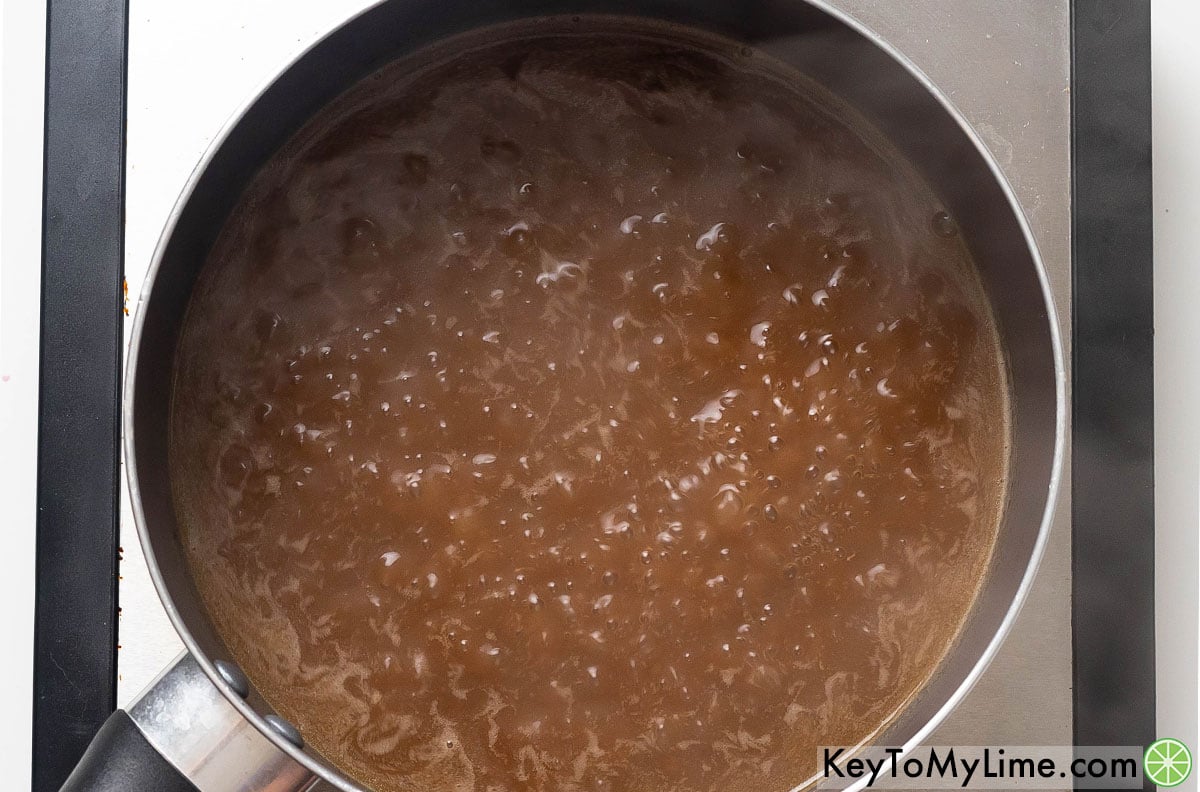 Whisking in worcestershire sauce and then bringing to a boil.