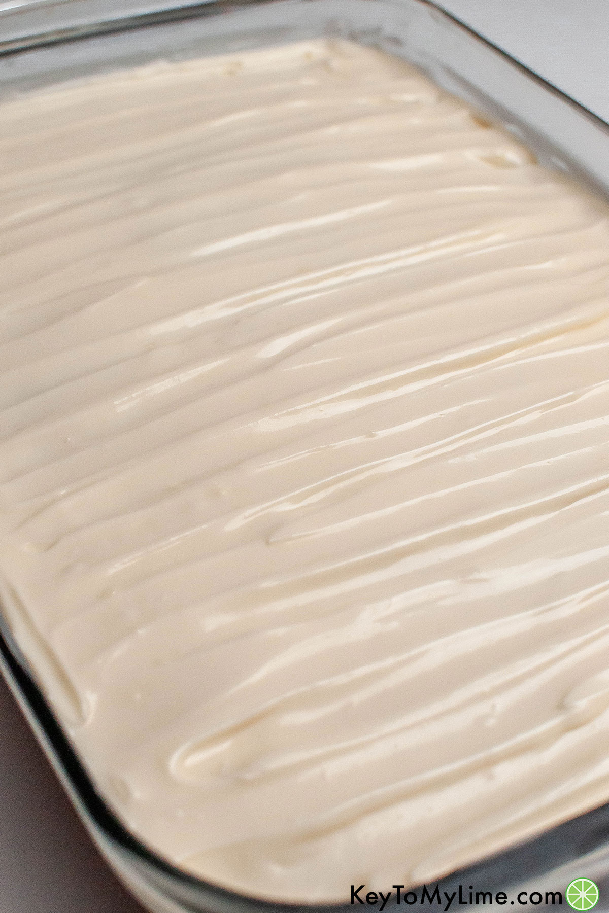 An image showing the texture of the cream cheese frosting spread out over the pumpkin cake.