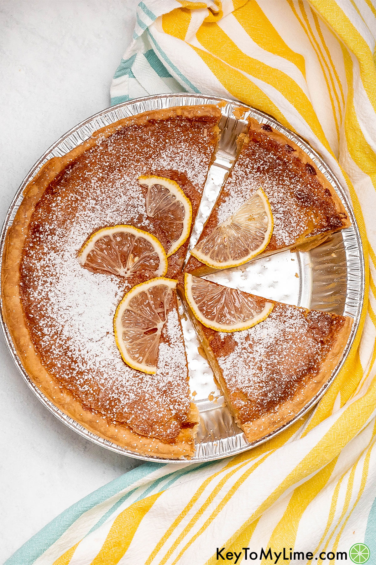 An overhead image of a partially cut pie with multiple slices missing.