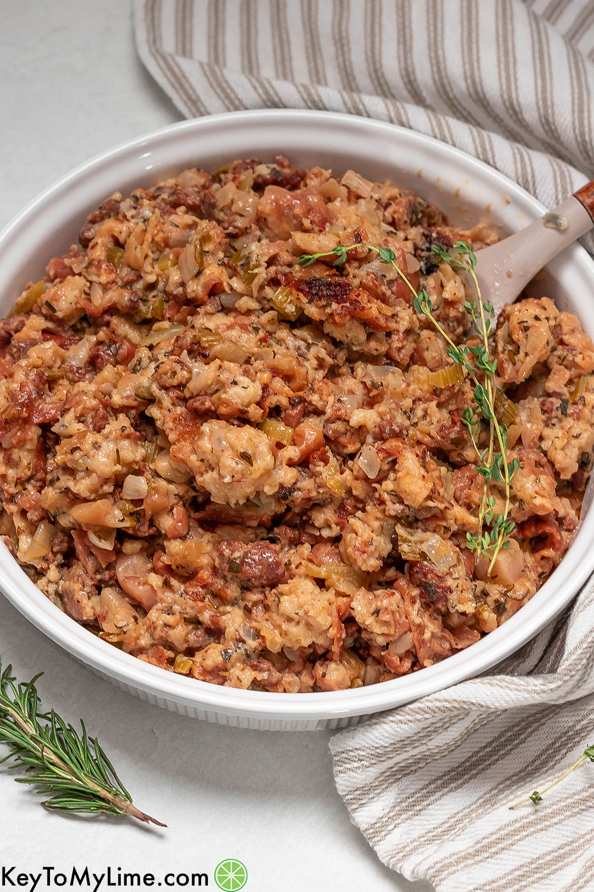 An over head image of a garnished stuffing side dish with fresh thyme on top.