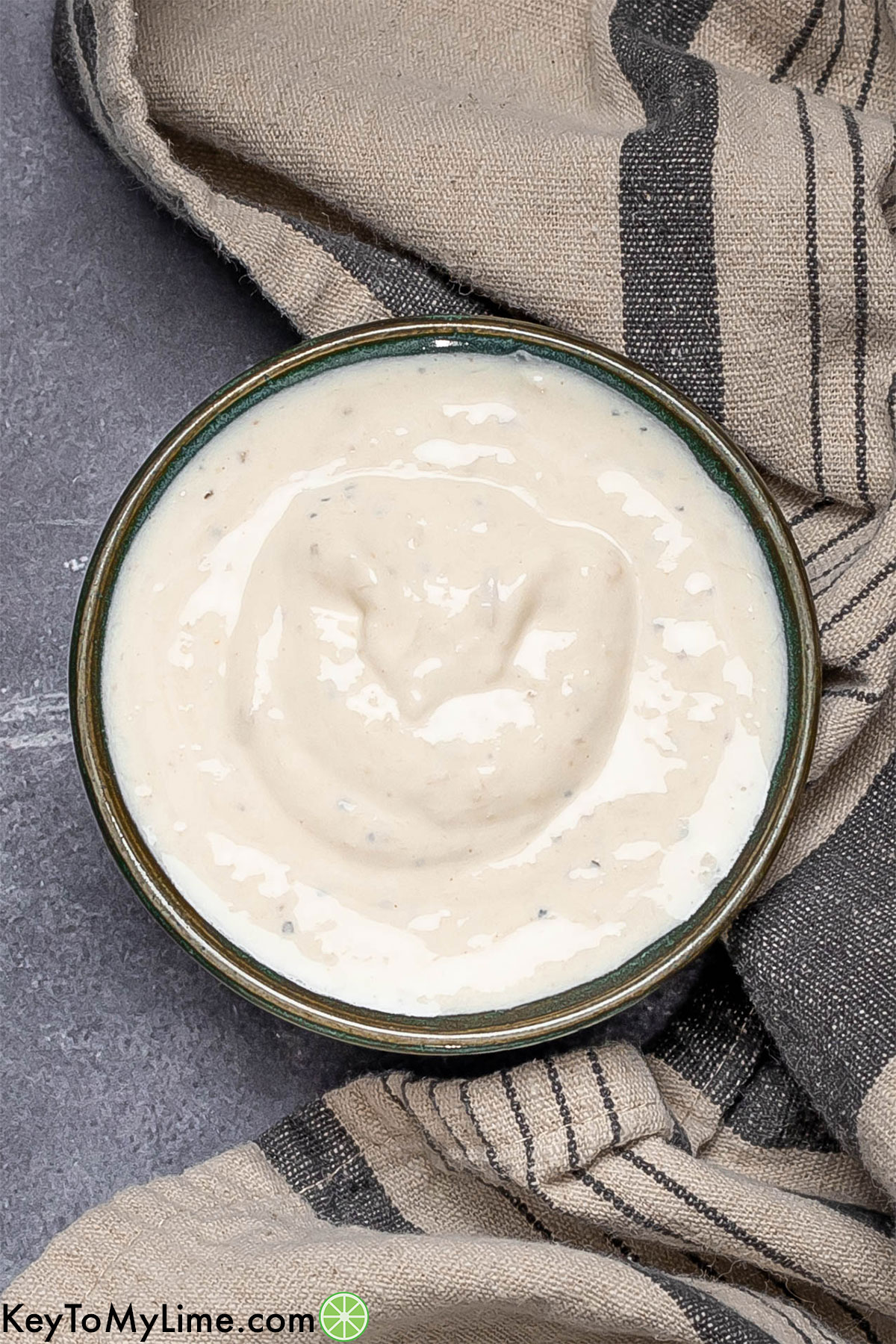 An image of freshly mixed horseradish sauce in a small bowl before garnishing.