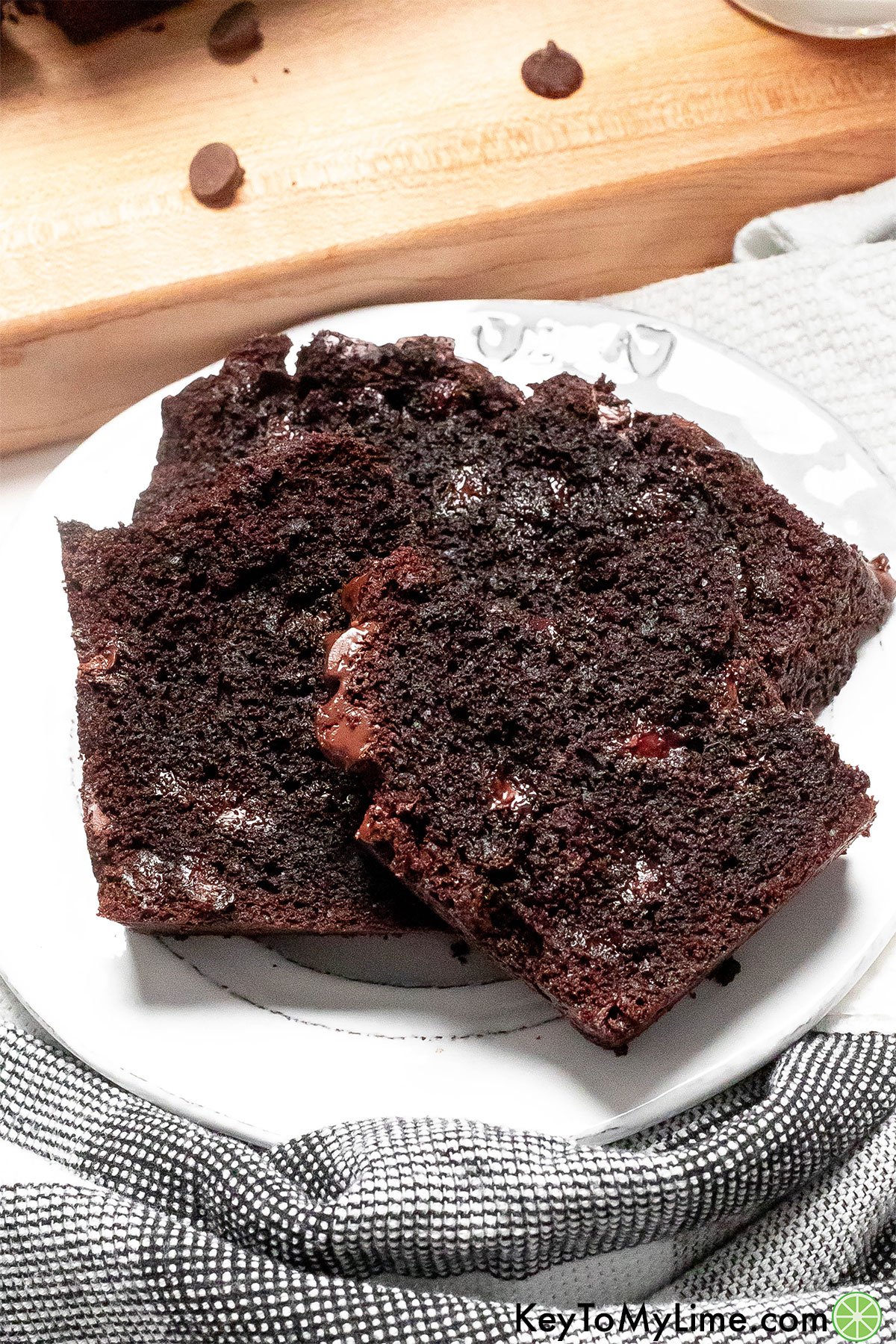 Slices of moist and rich chocolate bread on a white plate.