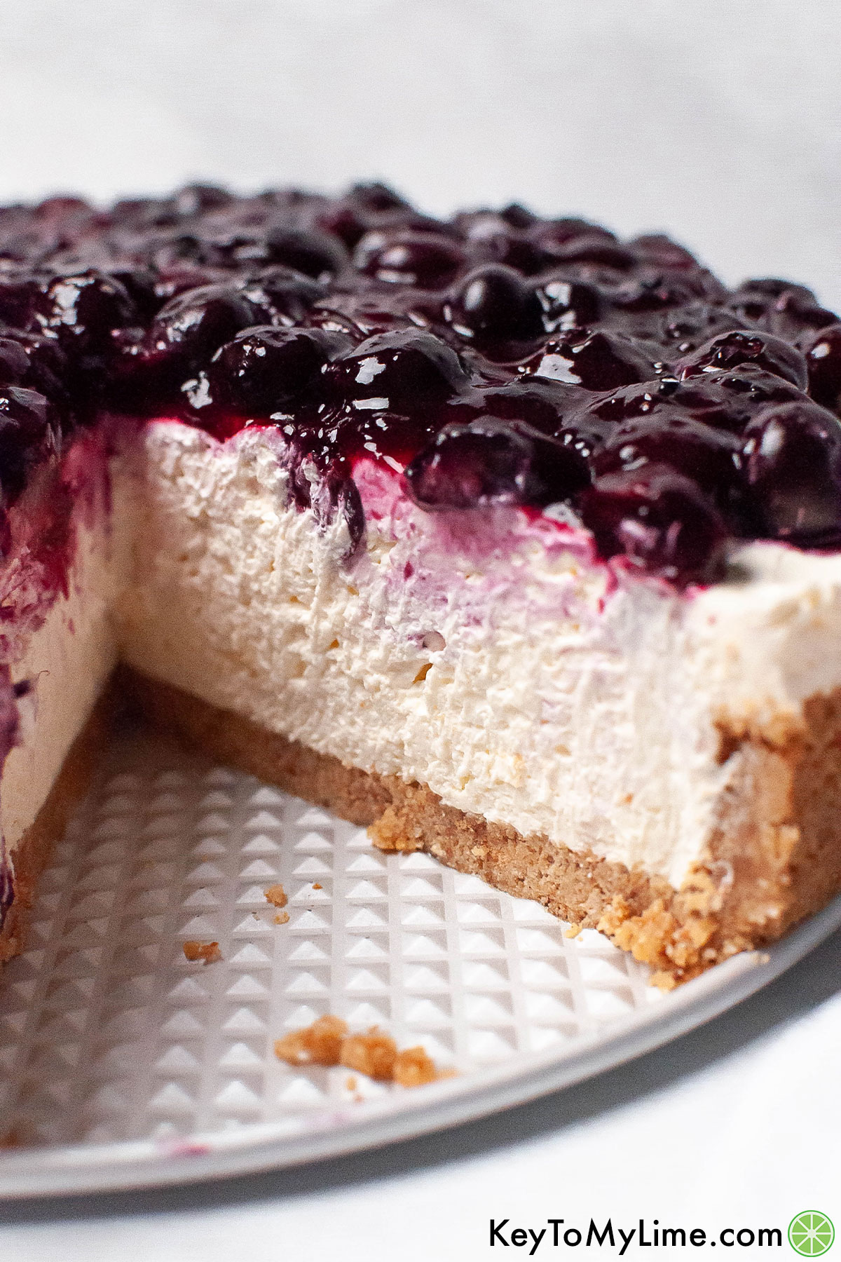 A cheesecake with a slice missing showing the individual layers of the cake.