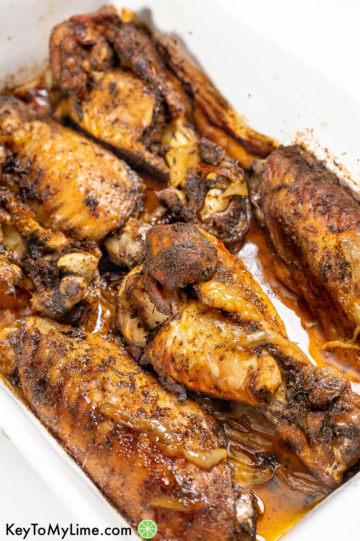 A side image of the baked turkey wings basted with juices and onions throughout.
