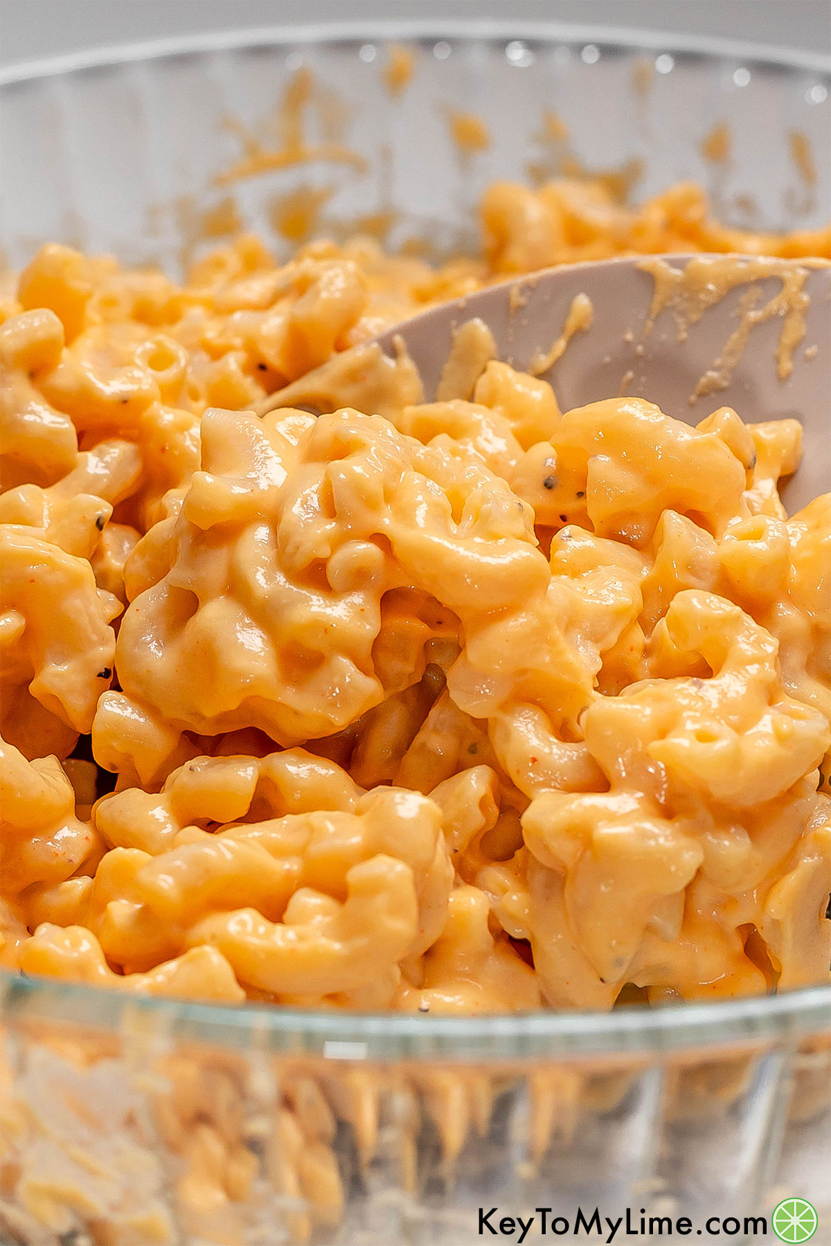 A close up image showing the cheese sauce texture over macaroni.