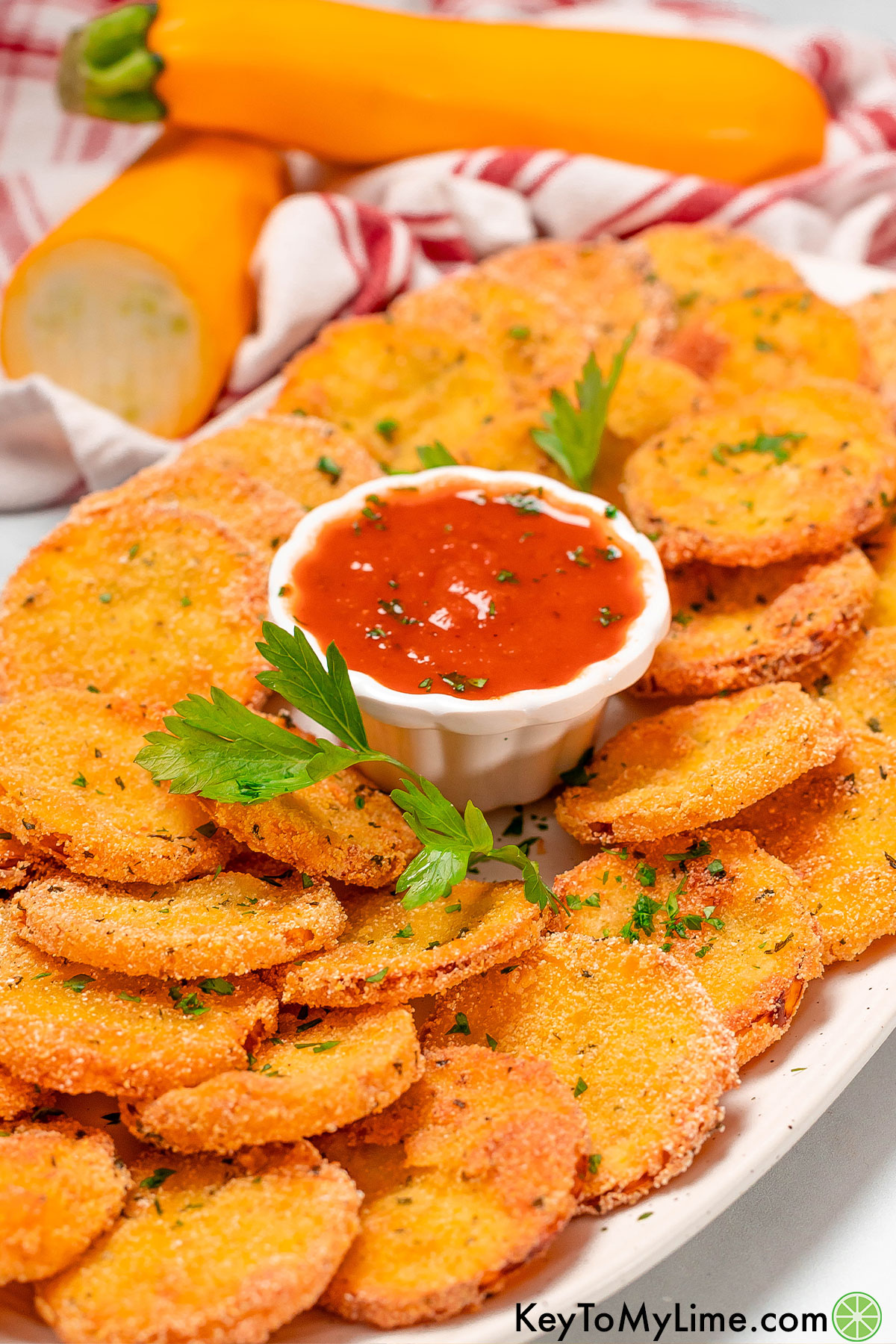 A side image of a platter with multiple layers of fried squash.