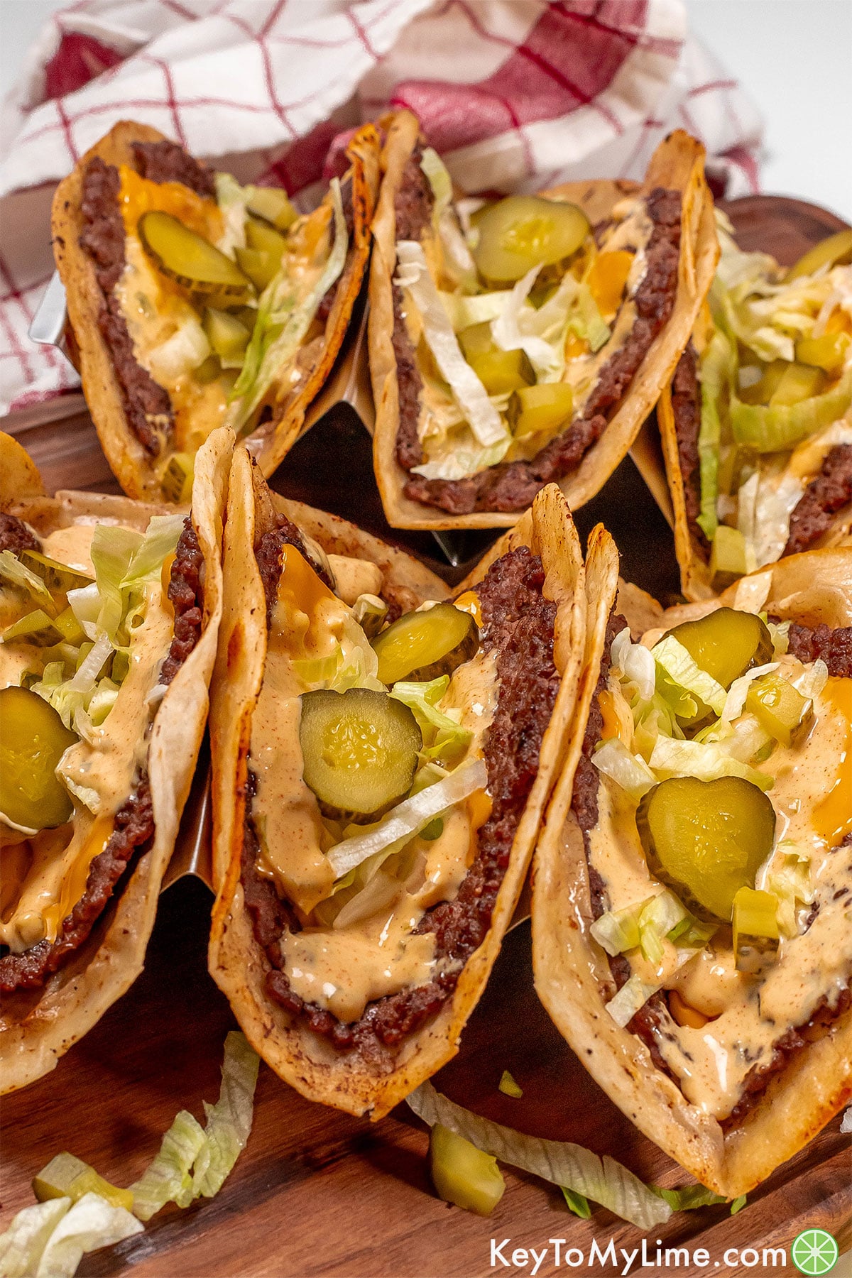 A close up side image of fully assembled tacos sitting in taco holders.