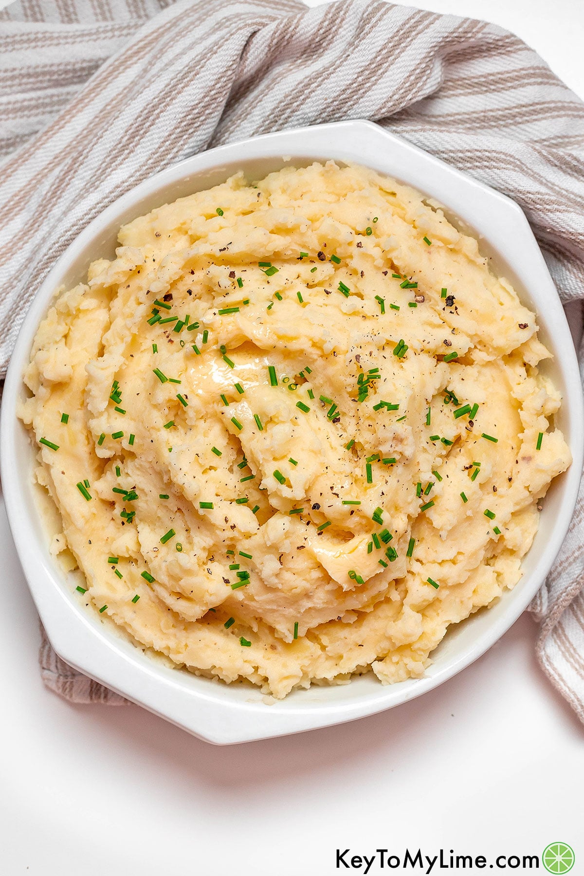 An overhead image of a delicious side dish of mashed potatoes with swirls throughout.