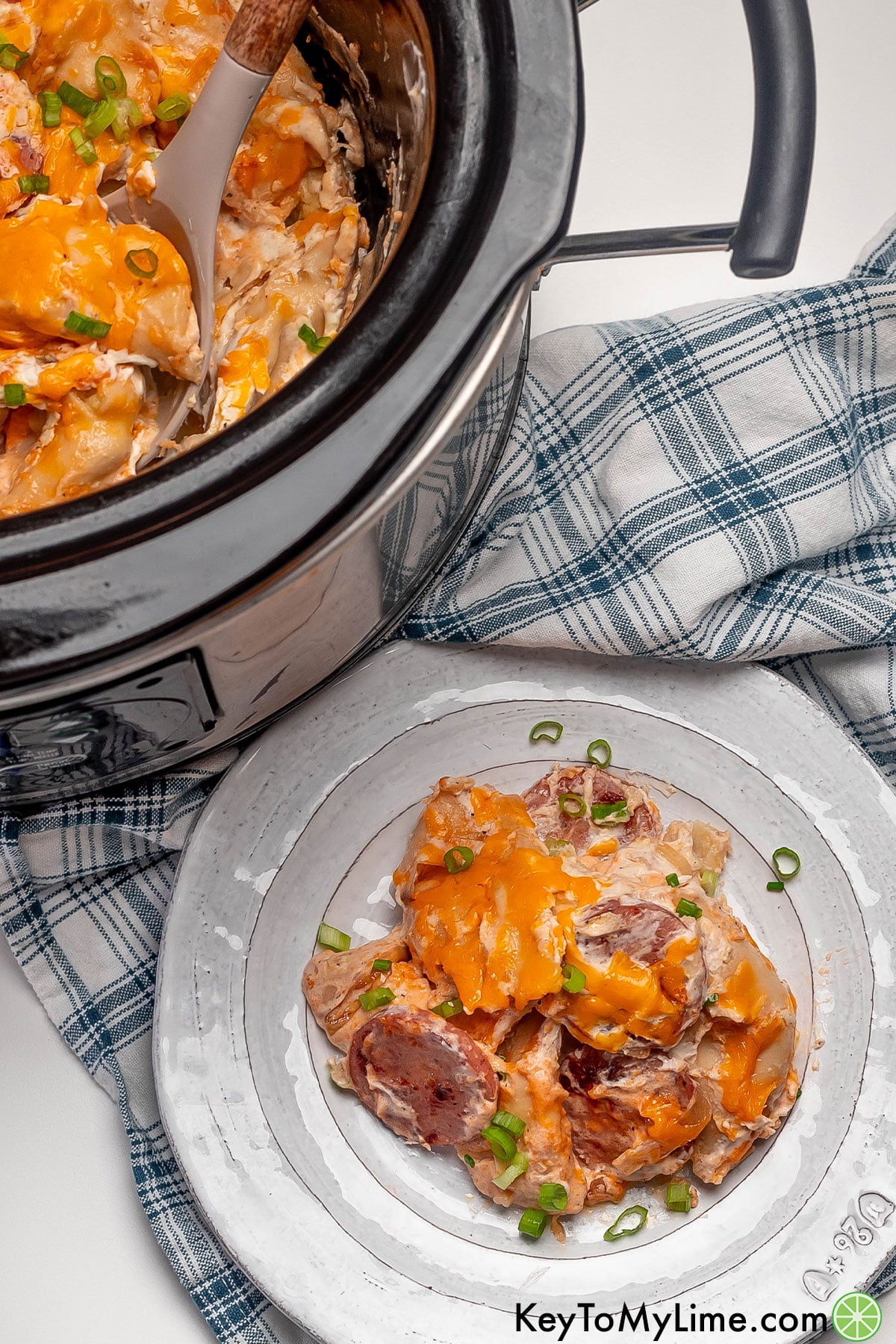An overhead image of a serving of casserole next to a crockpot.