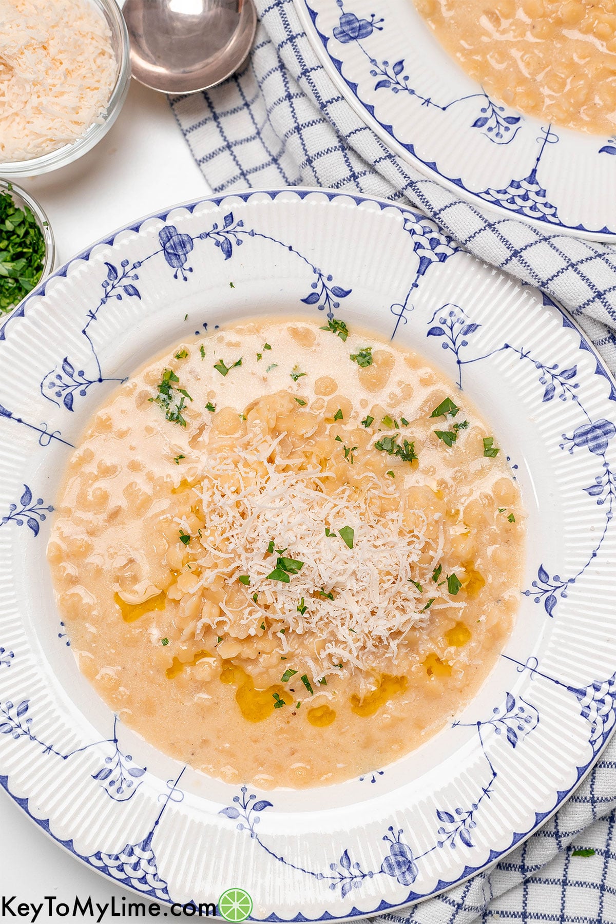 Pastina soup garnished with olive oil and fresh parsley on top.