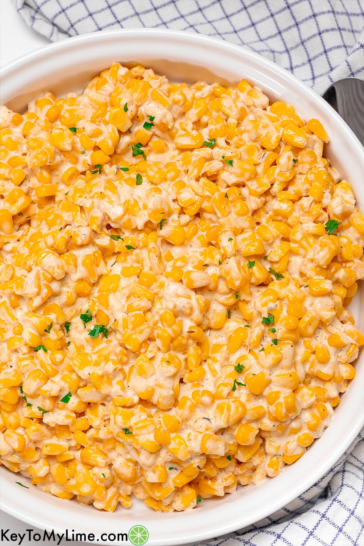 An overhead image of fully cooked Thanksgiving corn with fresh parsley on top.