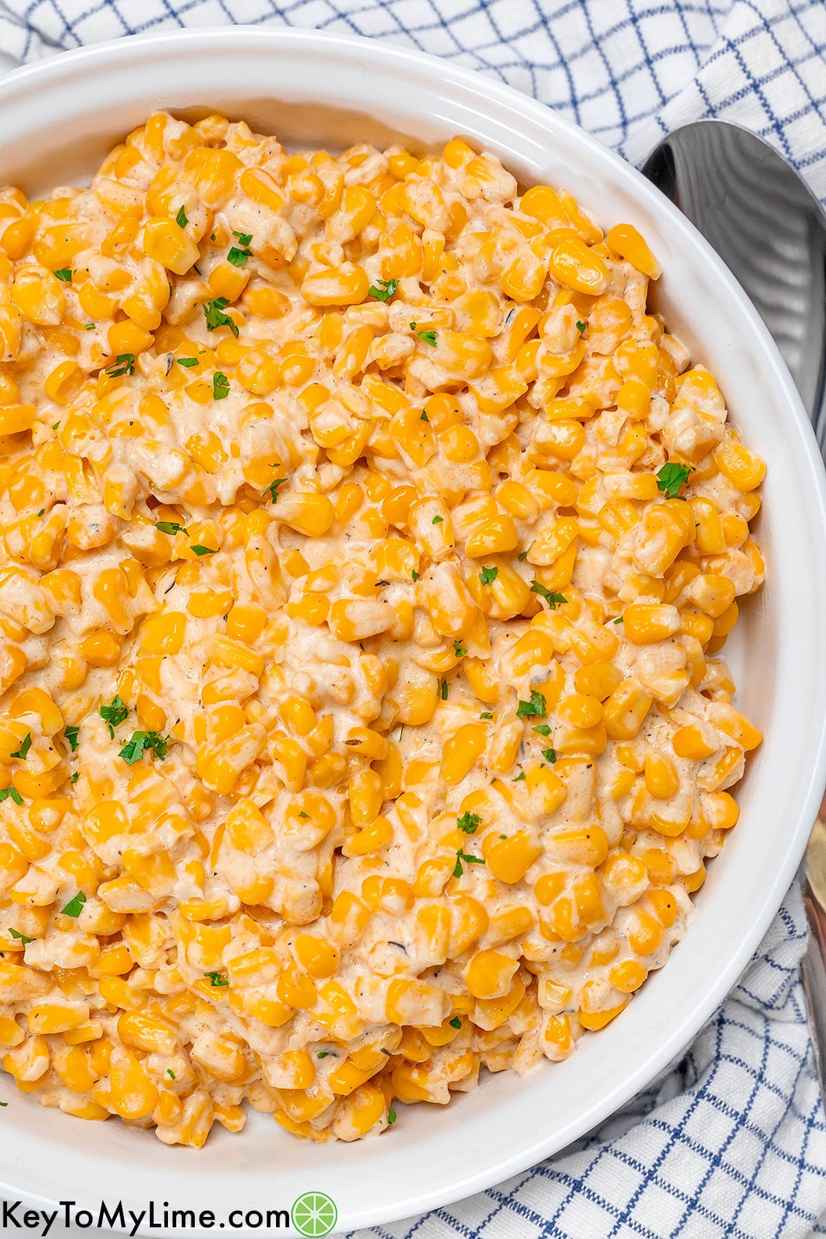 An overhead image of a creamy corn side dish in a large serving dish.