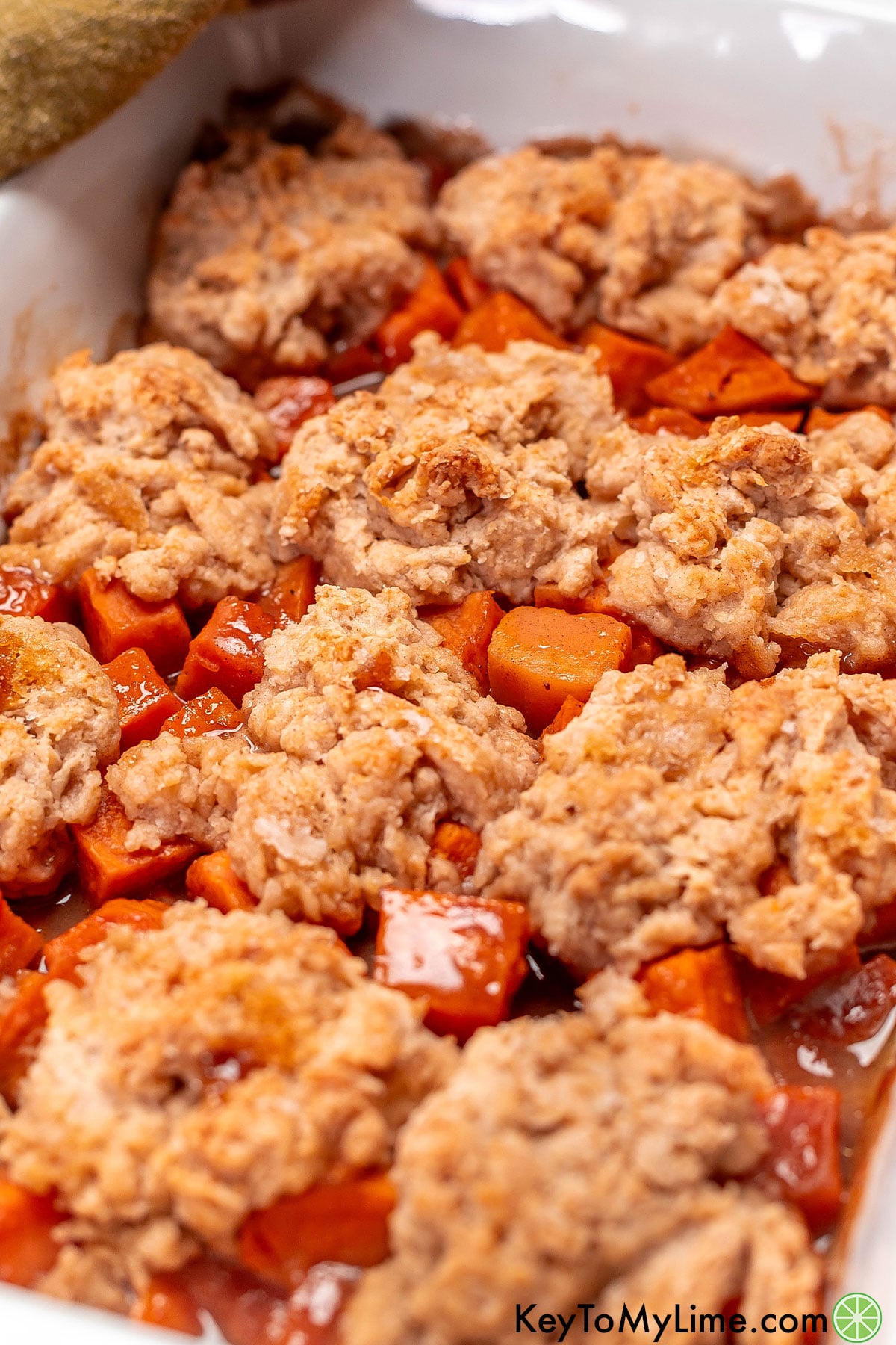 An overhead image of a freshly baked cobbler with delicious syrup throughout.