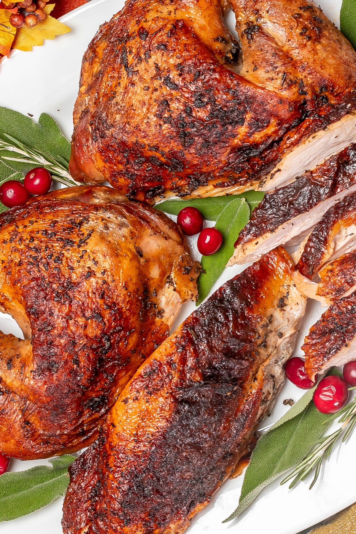 A partially carved turkey with beautiful seasonings throughout.