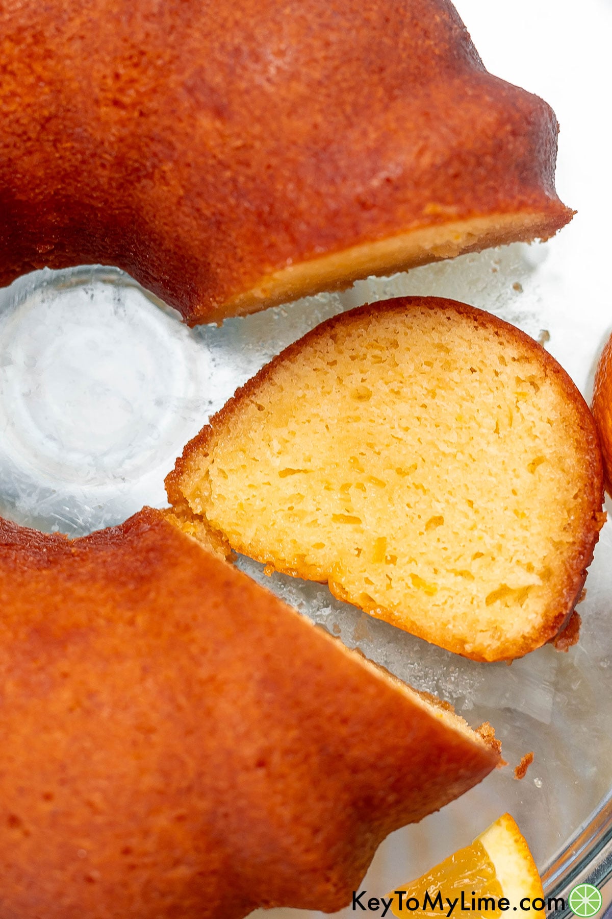 A close up overhead image of a sliced piece of cake resting on a platter.