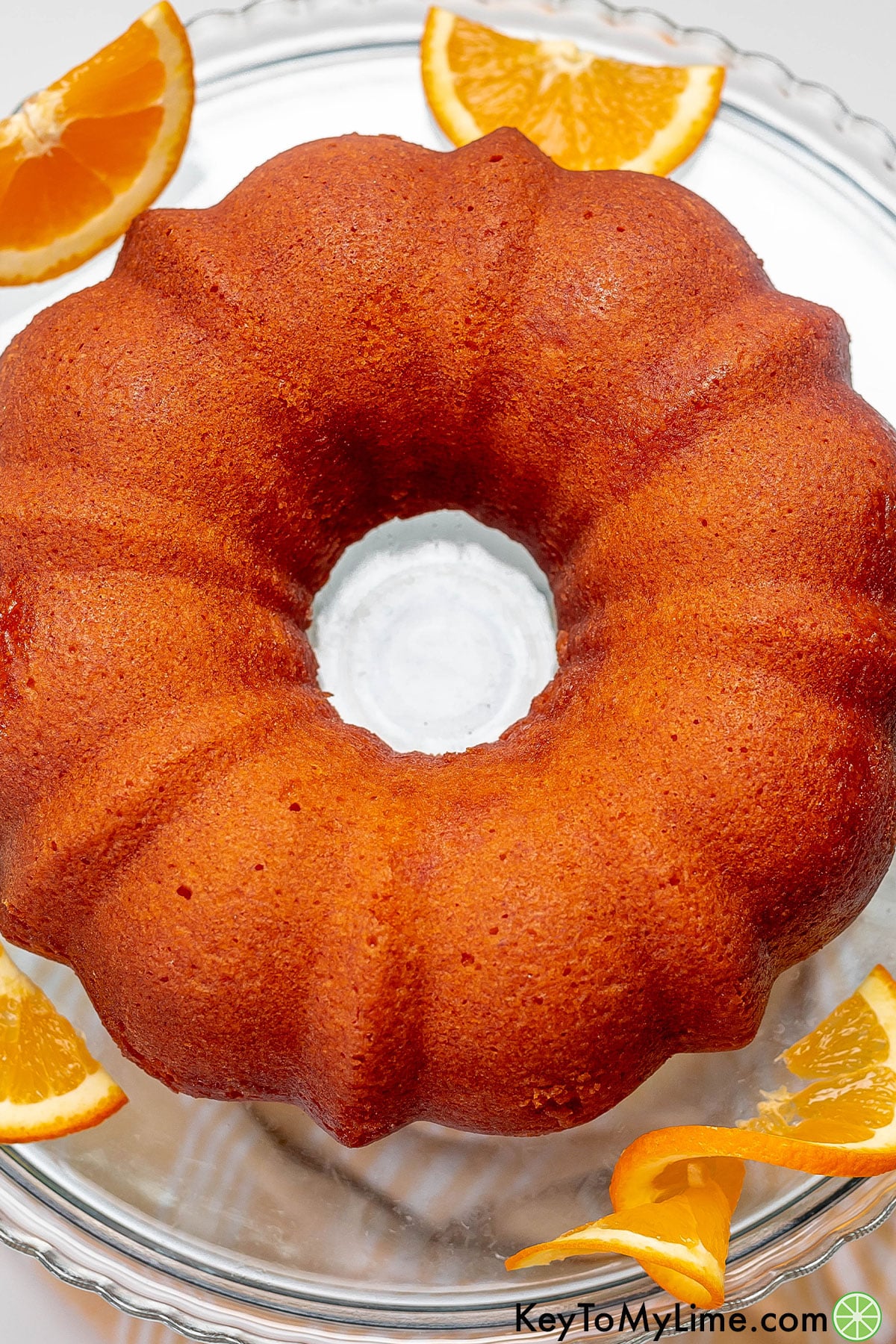 A freshly baked Bundt cake on a platter without garnish.
