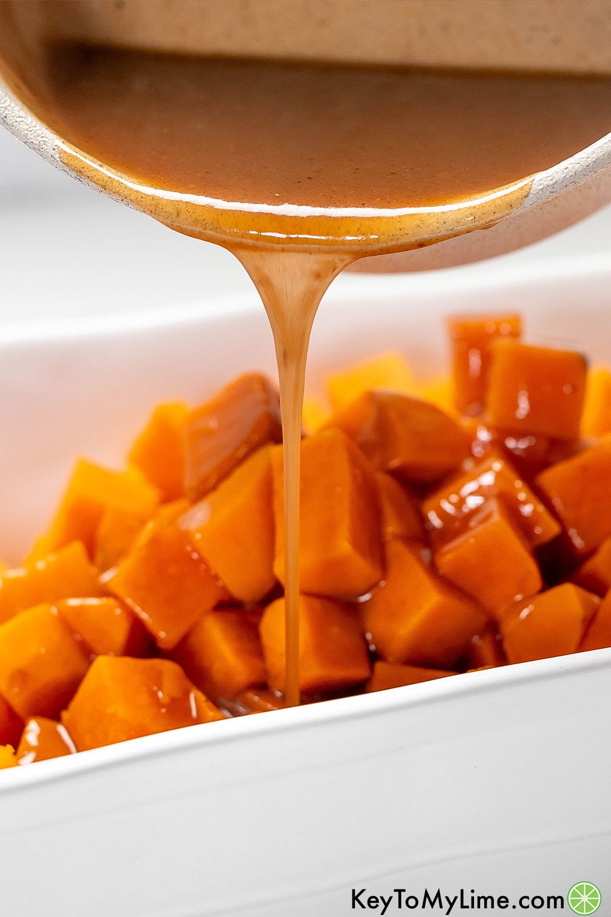 A close up of thick syrup poured over a sweet potato dessert dish.