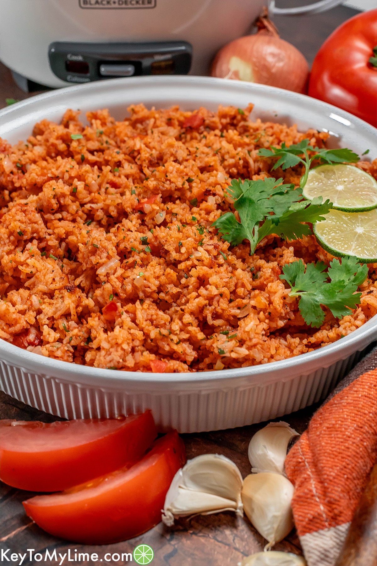A side image of a rice dish with garlic cloves to the side.