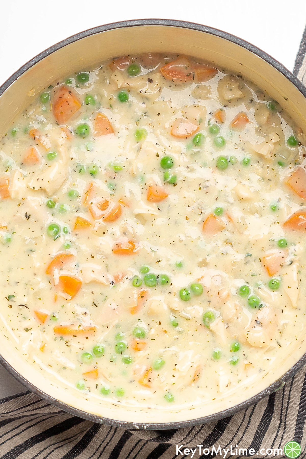 An overhead image of a fully cooked crustless pot pie in a large Dutch oven.